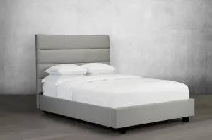 Upholstered Bed Featuring lofty tufted panels