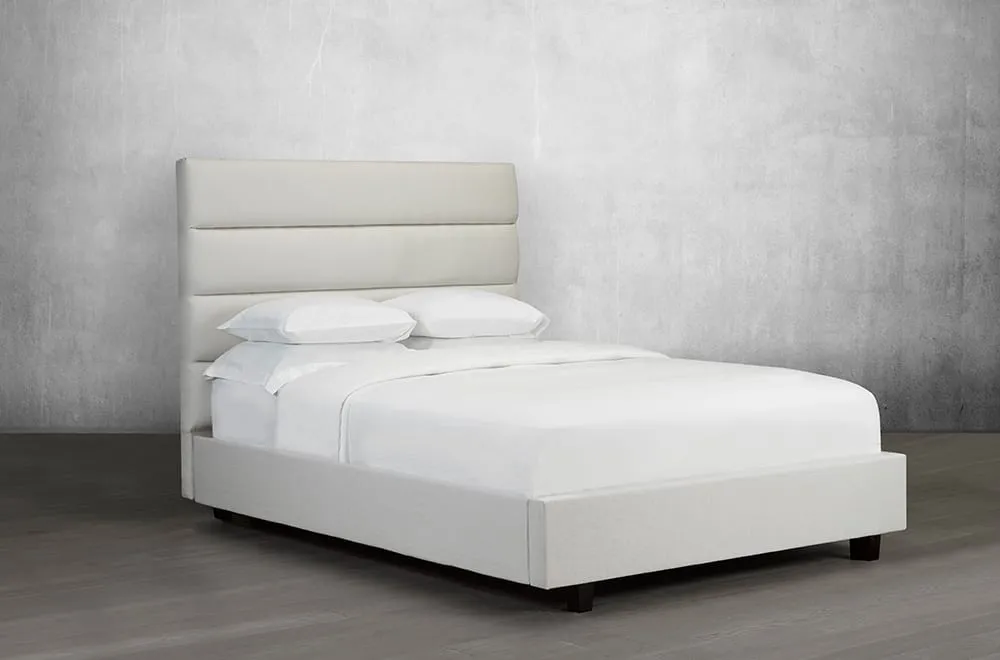 Upholstered Bed Featuring lofty tufted panels